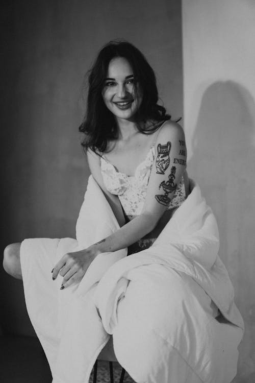 Woman in Tank Top Sitting with a Blanket