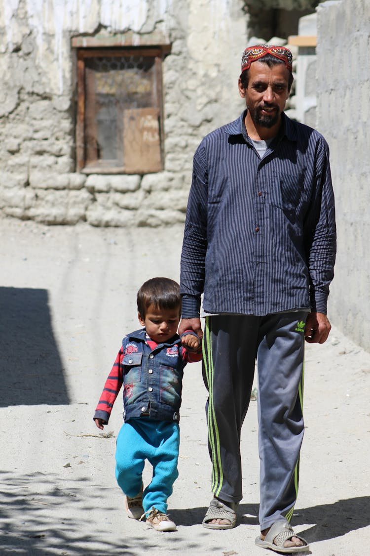 A Father And Son Walking Together 