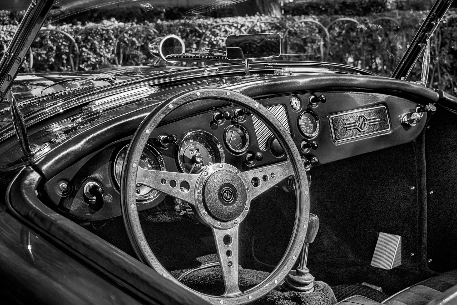 Explore the classic elegance of a vintage convertible car interior in this black and white photograph.
