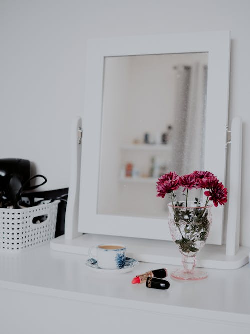 Vanity Space with Flowers, Lipstick and Coffee Standing on a Table 