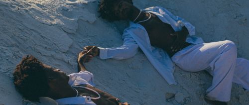 Free Elegant twins in white attire posing artistically in a sandy landscape in Brazil. Stock Photo