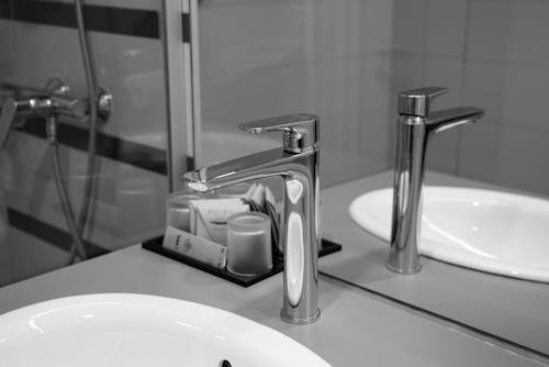 Free Stainless Steel Faucet Beside a Sink Stock Photo