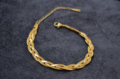 Free Gold Necklace on Gray Textile Stock Photo