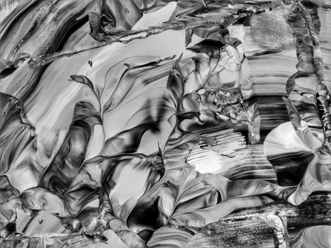 Dynamic abstract image with flowing lines in grayscale tones.