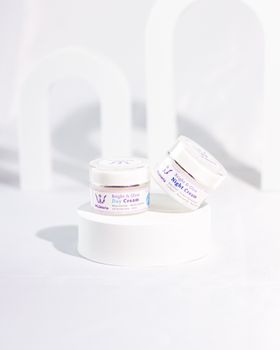 Elegant display of natural day and night creams in a bright setting.