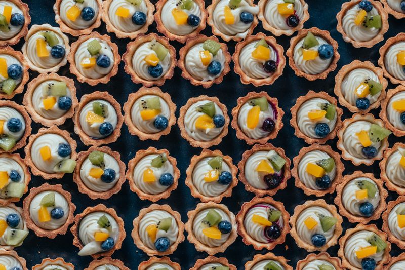small fruit tarts with pastry cream and berries