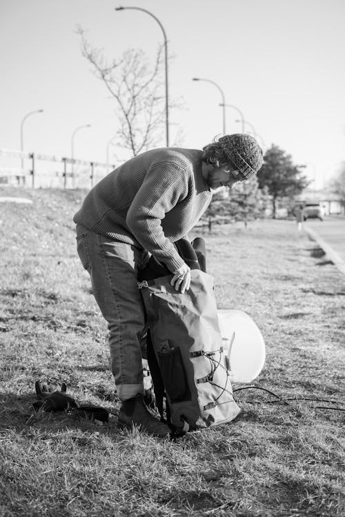 Man in Sweater Packing His Things