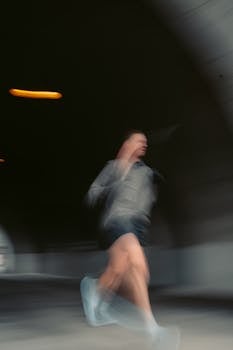 Artistic shot capturing the motion blur of a runner in a tunnel, Montreal. Perfect for illustrating speed and energy.