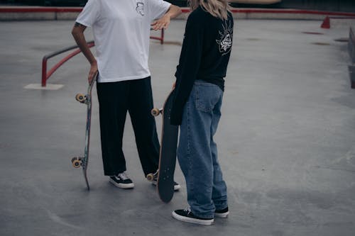 Teenagers at Skatepark Holding Skateboards