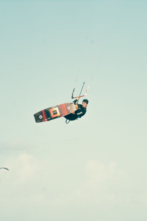 Free A kitesurfer performs an aerial trick against a clear sky in the Turks and Caicos Islands. Stock Photo