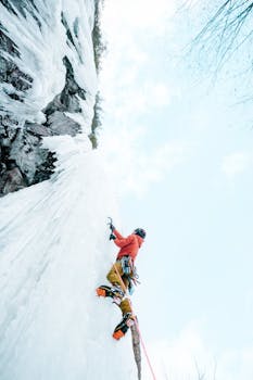 Thrilling ice climbing adventure on frozen walls in Quebec during winter.