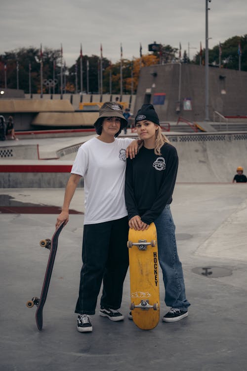 Teenage Women in a Skate Park Holding Skateboards