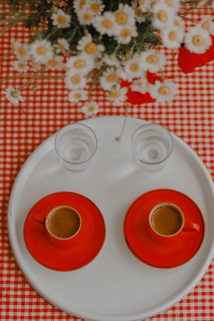 Coffee Mugs And Flowers On Table