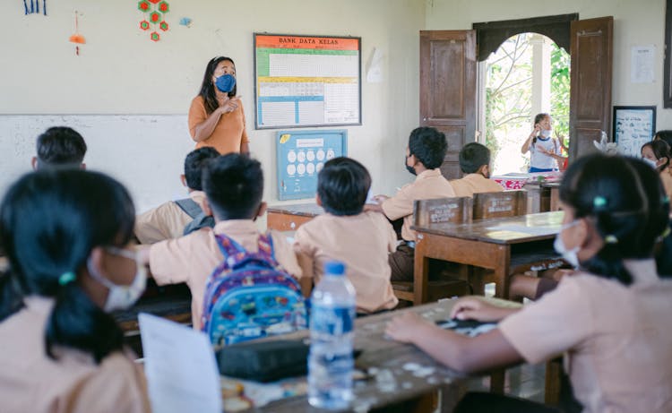 Woman Teaching Children In A Classroom