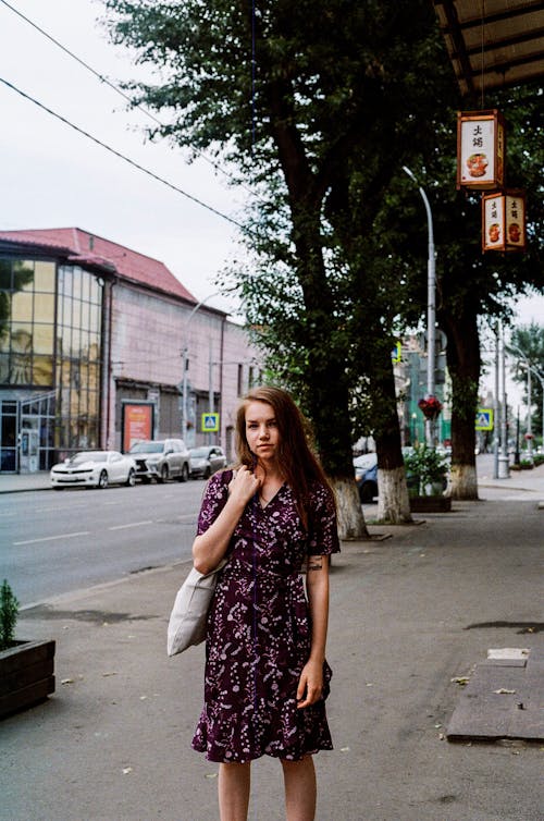 Woman Standing on the Sidewalk