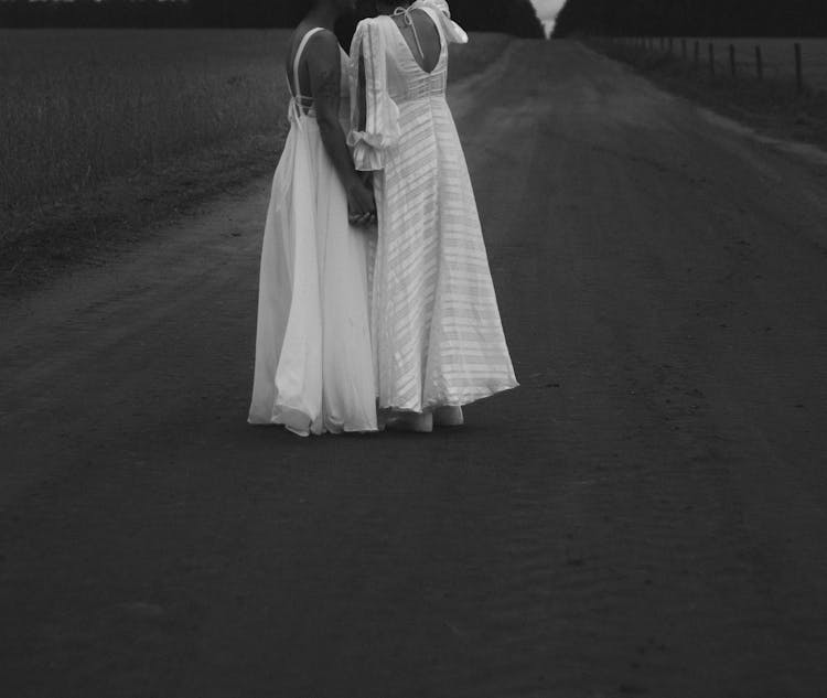 Two Women In Wedding Dresses On Road