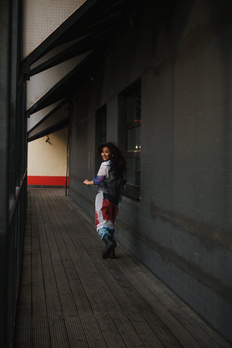 Woman Running Through Dark Hallway