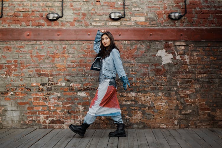 Woman Walking By Old Brick Wall