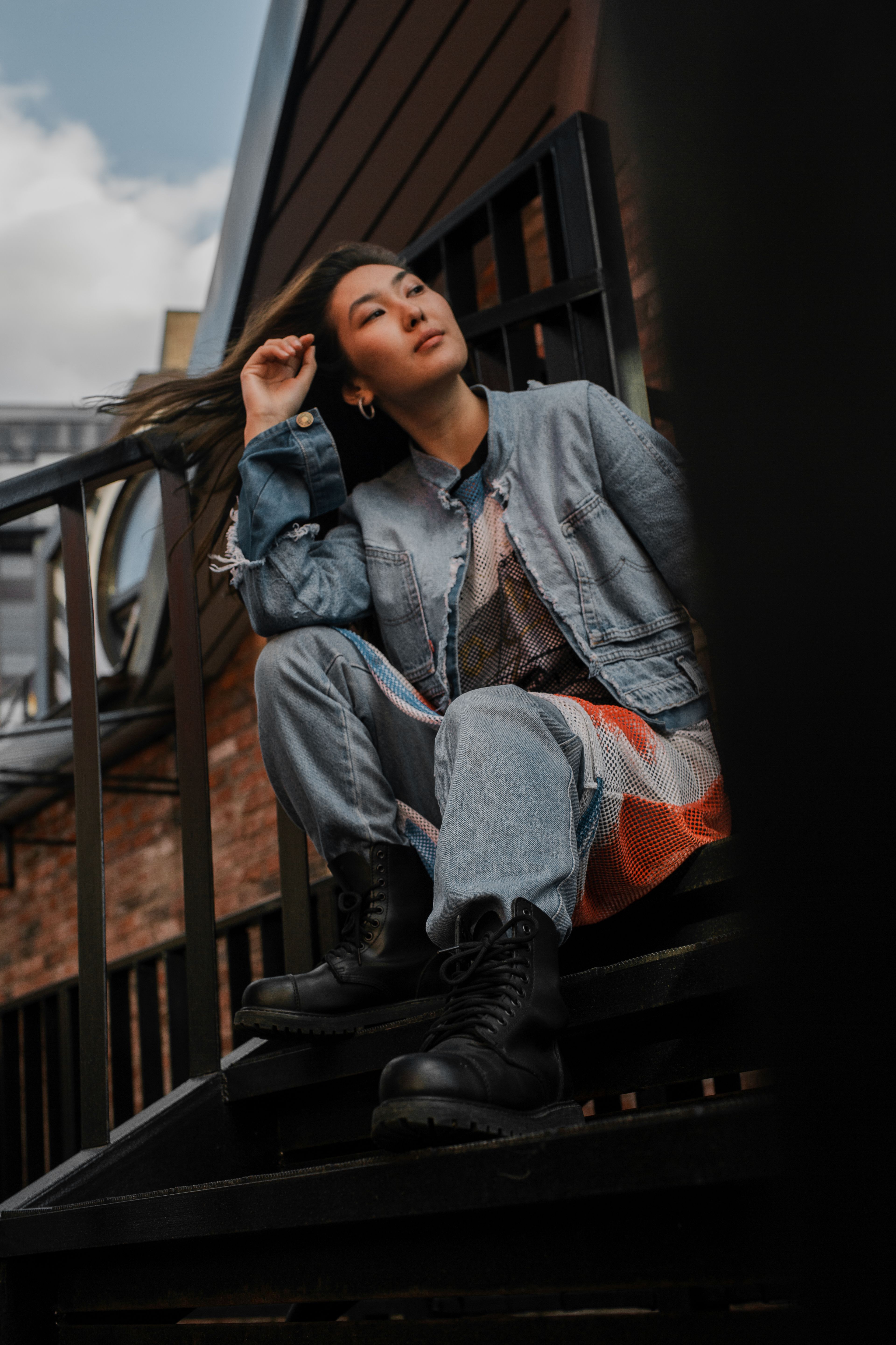 Woman in Denim Jacket Sitting on Stairs · Free Stock Photo