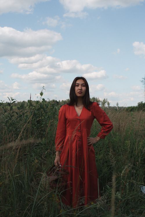 Woman in Red Dress on a Grassy Field · Free Stock Photo