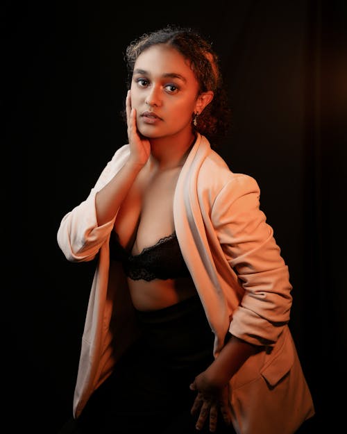 Woman in Brassiere and Blazer Posing