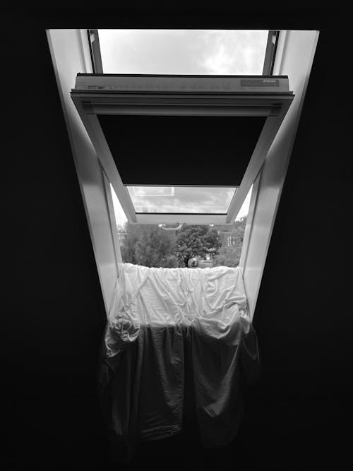 Free Fabric Hanging from an Open Window Stock Photo