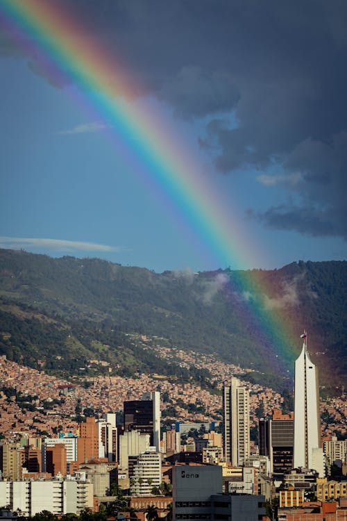 Free City Skyline Under Blue Sky With Rainbow Stock Photo
