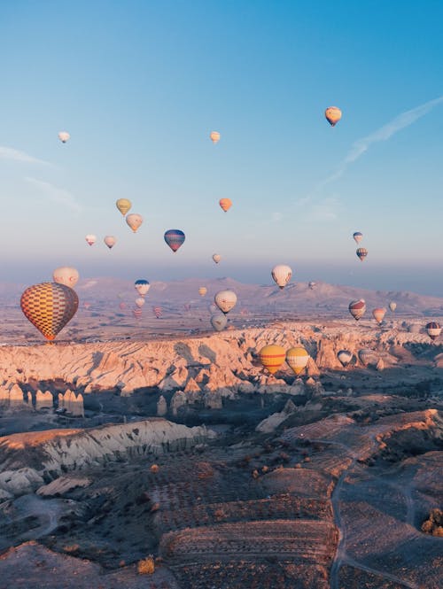 Hot Air Balloons Floating over Mountainous Landscape
