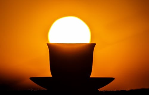 Silhouette Of Teacup On Saucer During Sunset