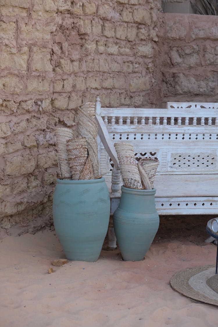 Rolls Of Rugs In Clay Pots