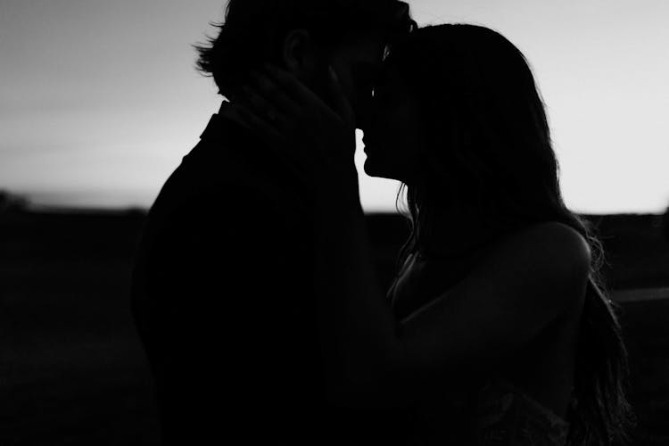 Silhouette Of Couple Kissing