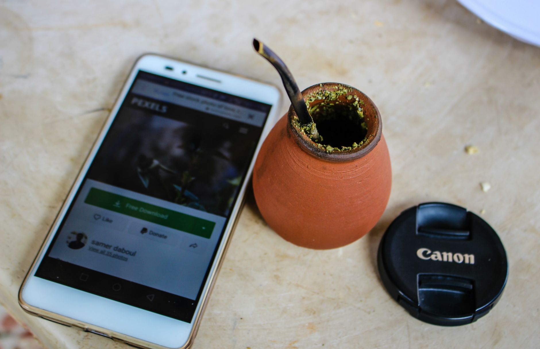 암보험 보험금 청구, 복잡한 서류 준비 한 번에 끝내기 2 A flat lay of a smartphone, yerba mate cup, and camera lens cap on a table.