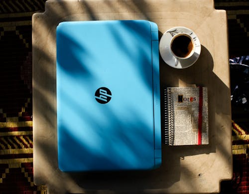Top View Photo of Laptop Near Coffee Cup