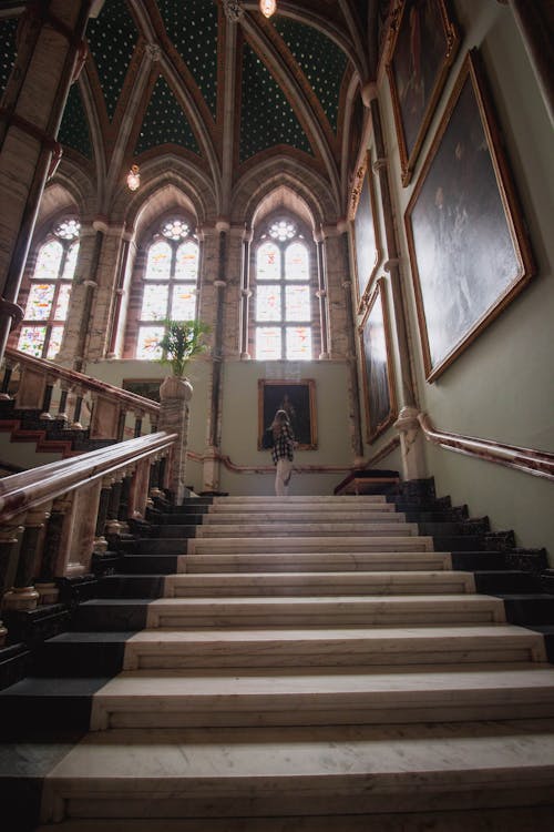 Low Angle View of Marble Steps and a Woman Looking at a Painting 