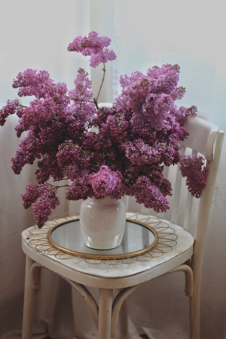 Purple Lilac Flowers In A White Vase