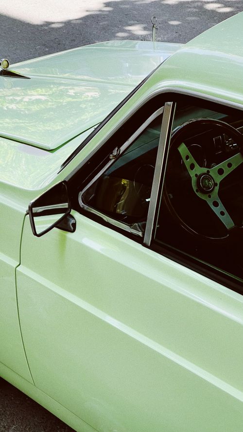 Free A close-up of a mint green vintage car in a sunny İstanbul street. Stock Photo