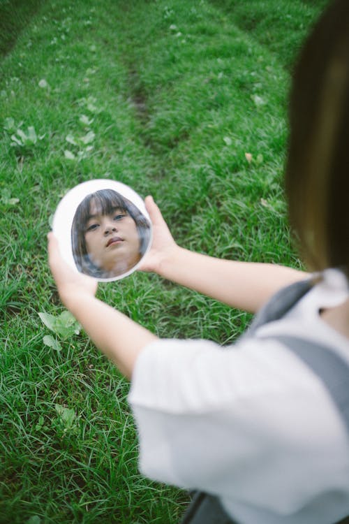 Woman Holding a Round Mirror