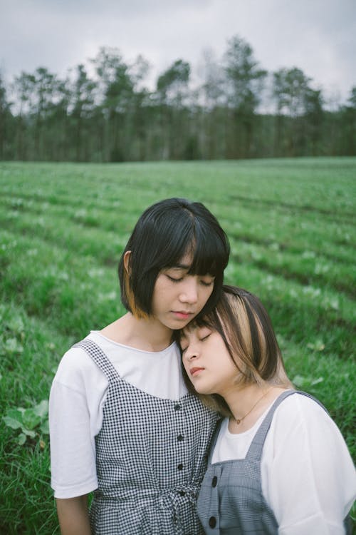 Portrait of Girls Standing on a Grass Field