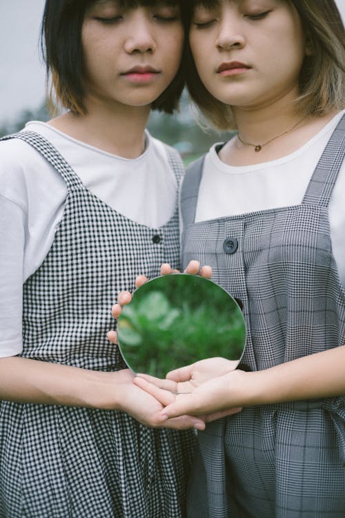 Two Girls Holding a Mirror