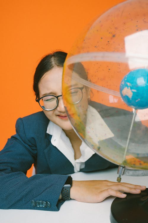 A Woman Sitting with a Globe