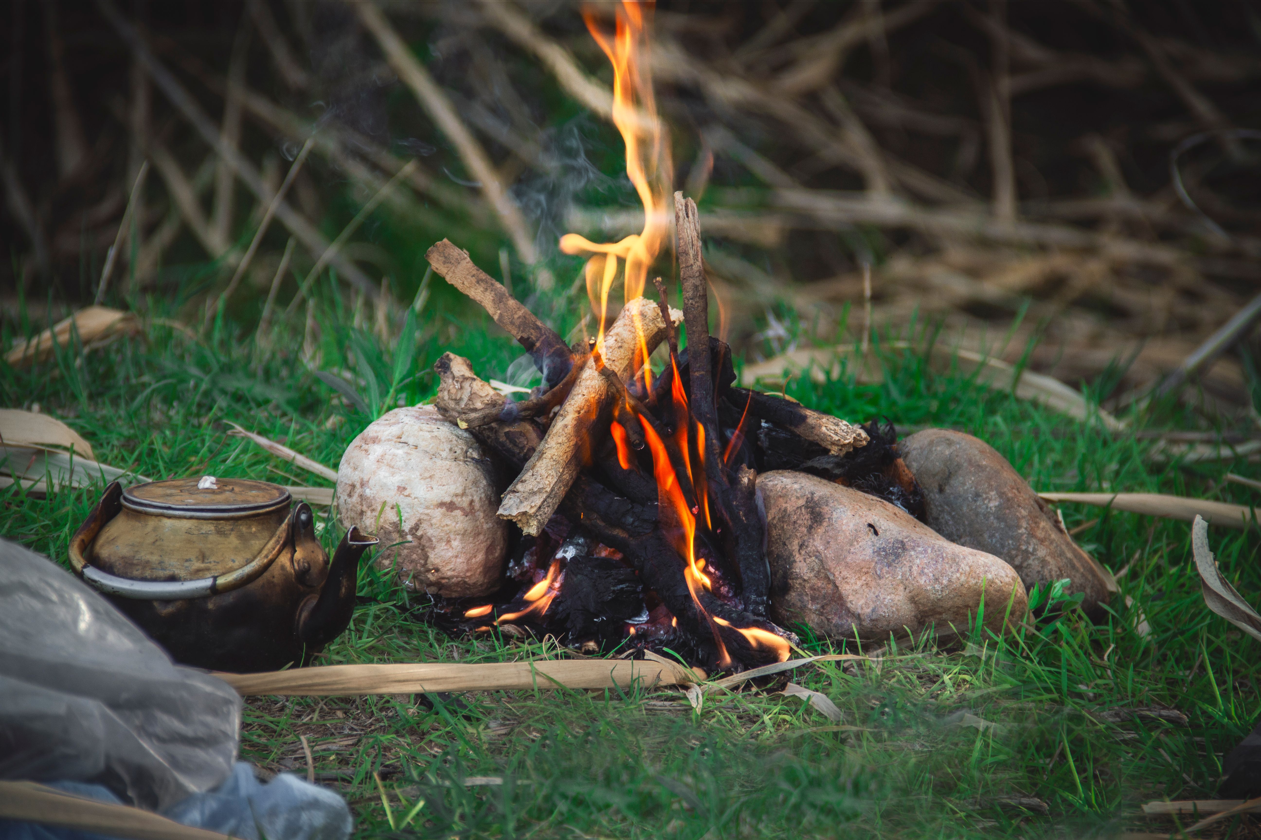 A tranquil outdoor campfire with a kettle, offering a warm ambiance in Morocco. - Khenifra