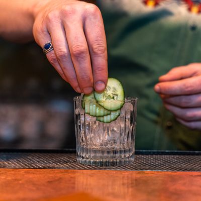 Bartender finishing a cocktail over a dark bar — Peps Silvestro on Pexels