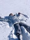 Man in Blue Jacket Lying on Snow Covered Ground