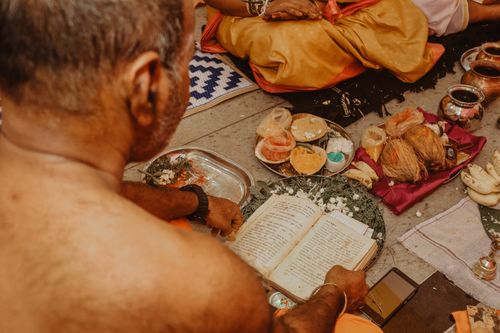 Free An intimate view of a traditional ceremony with ritual offerings and sacred texts. Stock Photo