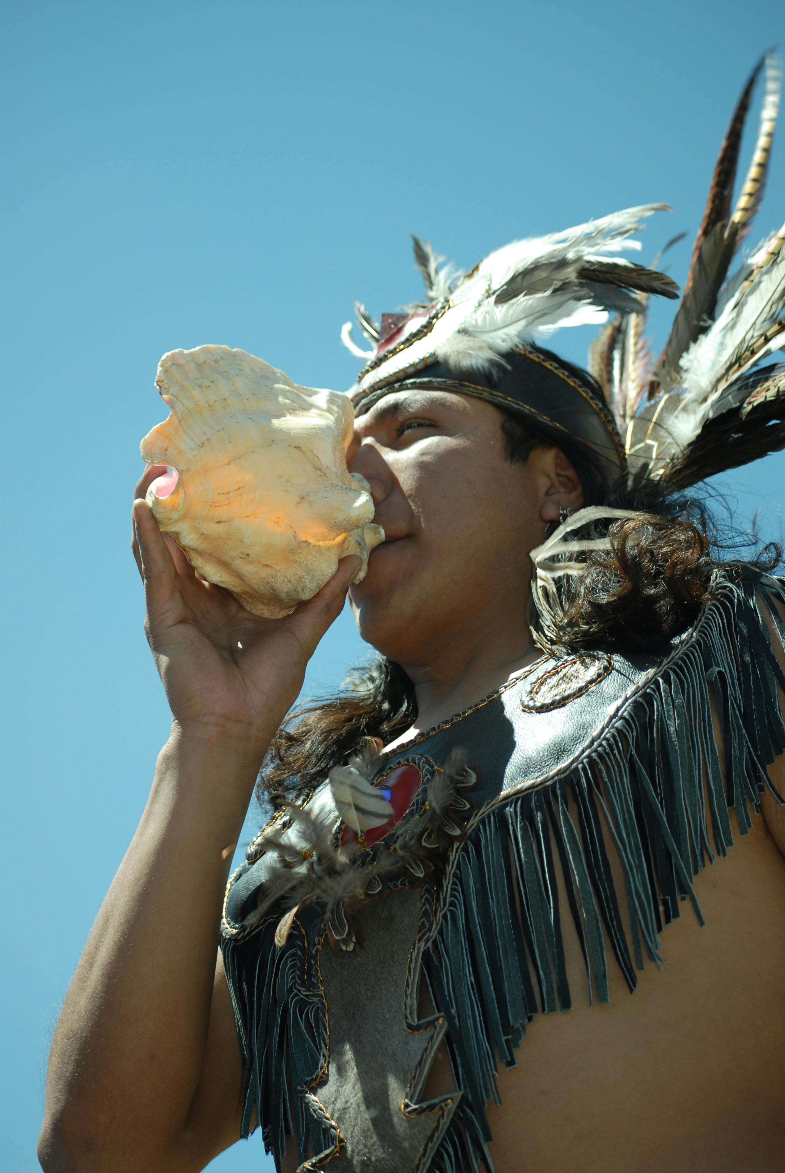 Man Blowing Conch Shell · Free Stock Photo