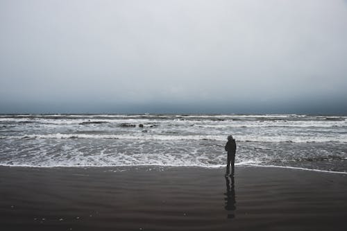 Person Standing Near Sea 