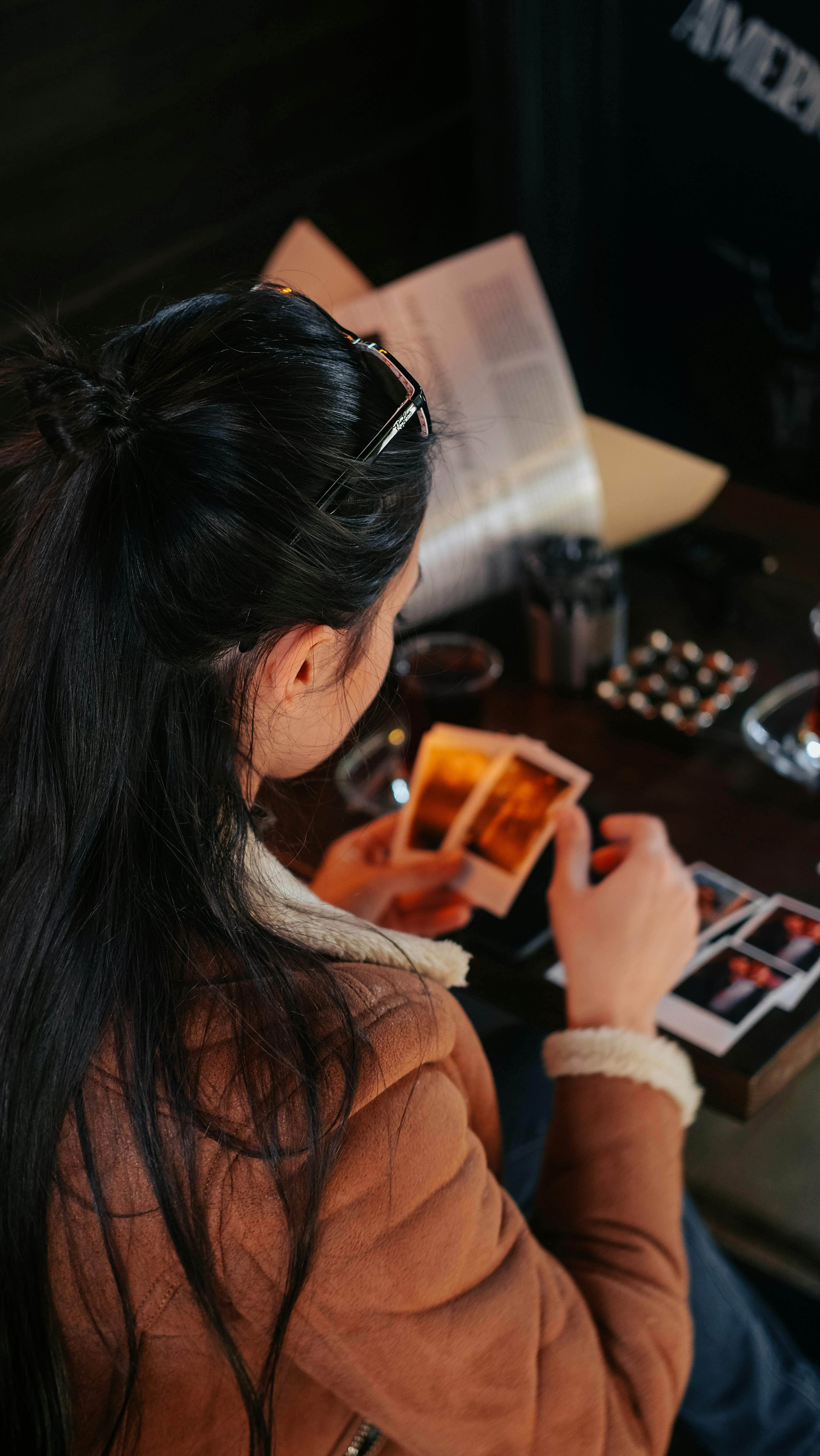 Woman in a cafe browsing through photographs in Yalova, Turkey.