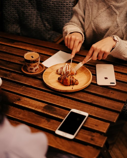 Woman Eating Croissants and Drinking Coffee