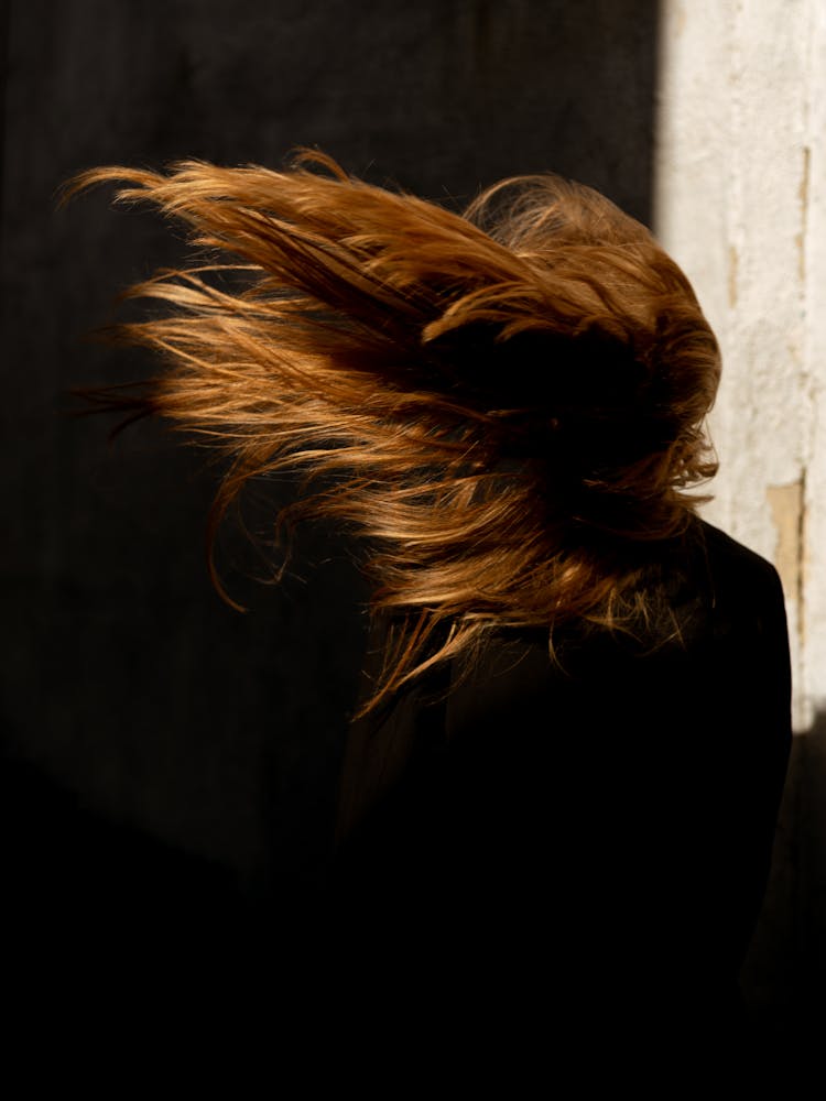 A Woman Standing With Her Back Toward The Camera