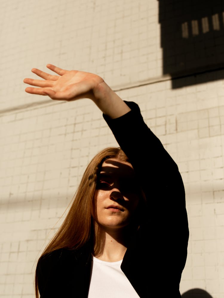 Woman Shielding Her Eyes From The Sunlight